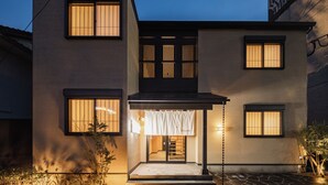 A two-story building with a covered entrance and a visible interior. - BEPPU Risana (Beppu)