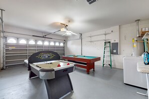A room with a foosball table, a pool table, and a ceiling fan. - 15 Min to Disney | Spacious 4BR Home w/ Pool (Kissimmee)