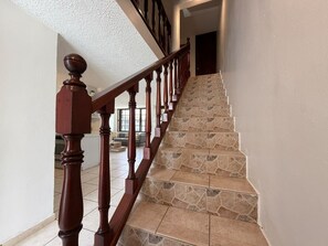 A staircase with wooden balusters and stone steps.
