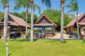 A resort with multiple cabins, a central building with large windows, and a golf cart. - Boat, Fish & Swim: Lakefront Cabin in Okeechobee! (Okeechobee)
