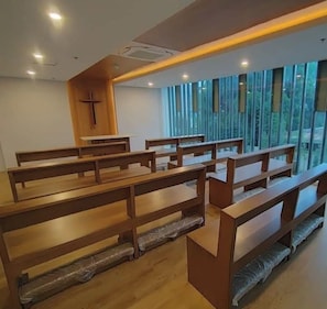 Experience the serene atmosphere of this historic church, featuring wooden pews and a simple design.