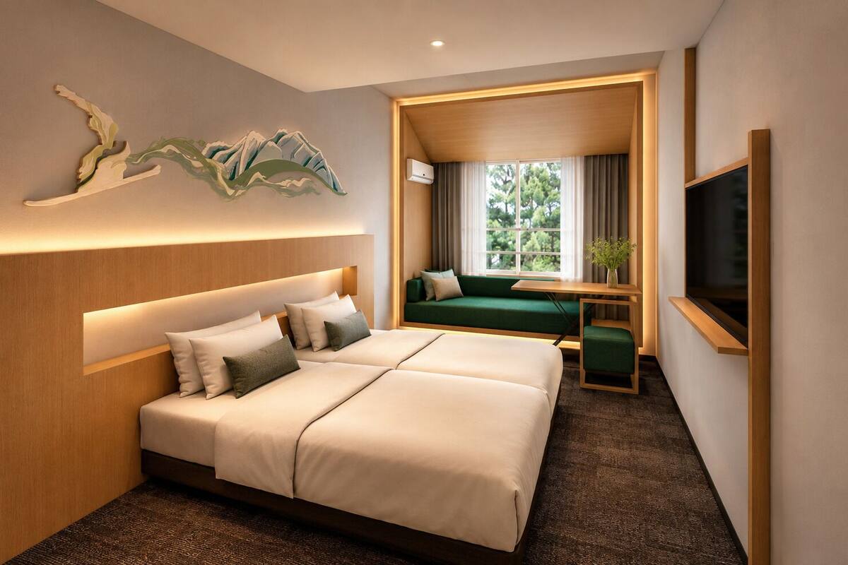 A hotel room with a large bed, a sofa, a TV, and a window with a view of greenery.