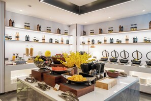 A well-organized buffet area with various food items and beverages displayed on shelves and counters. - Home Selection Hangzhou Xihu Hubin Yintai i77 Store  (Hangzhou)