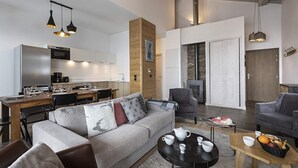 A modern living space with a kitchen, dining area, and seating area.