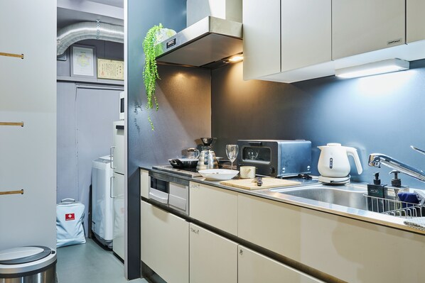 A modern kitchen with stainless steel appliances, a built-in oven, and a sink.
