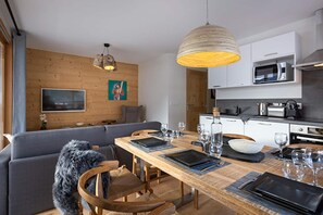 A modern kitchen with white cabinets, a microwave, and a kettle. - Apartment in Alpe d'Huez near Grandes Rousses (VAUJANY)