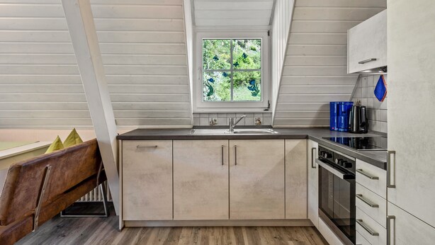 A kitchen with a window, cabinets, a sink, and a stove. - Apartment '2, 45qm' with Mountain View, Shared Terrace and Wi-Fi (Oberwolfach)
