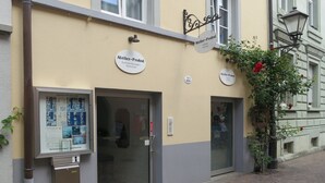 A building with a sign reading 'Atelier-Probst' and a door with a glass panel. - Holiday Apartment 'K3ab, 60sqm' with Balcony and Wi-Fi (Konstanz)
