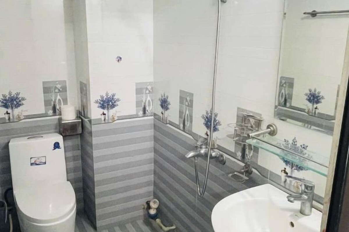 A bathroom with a toilet, sink, and shower.