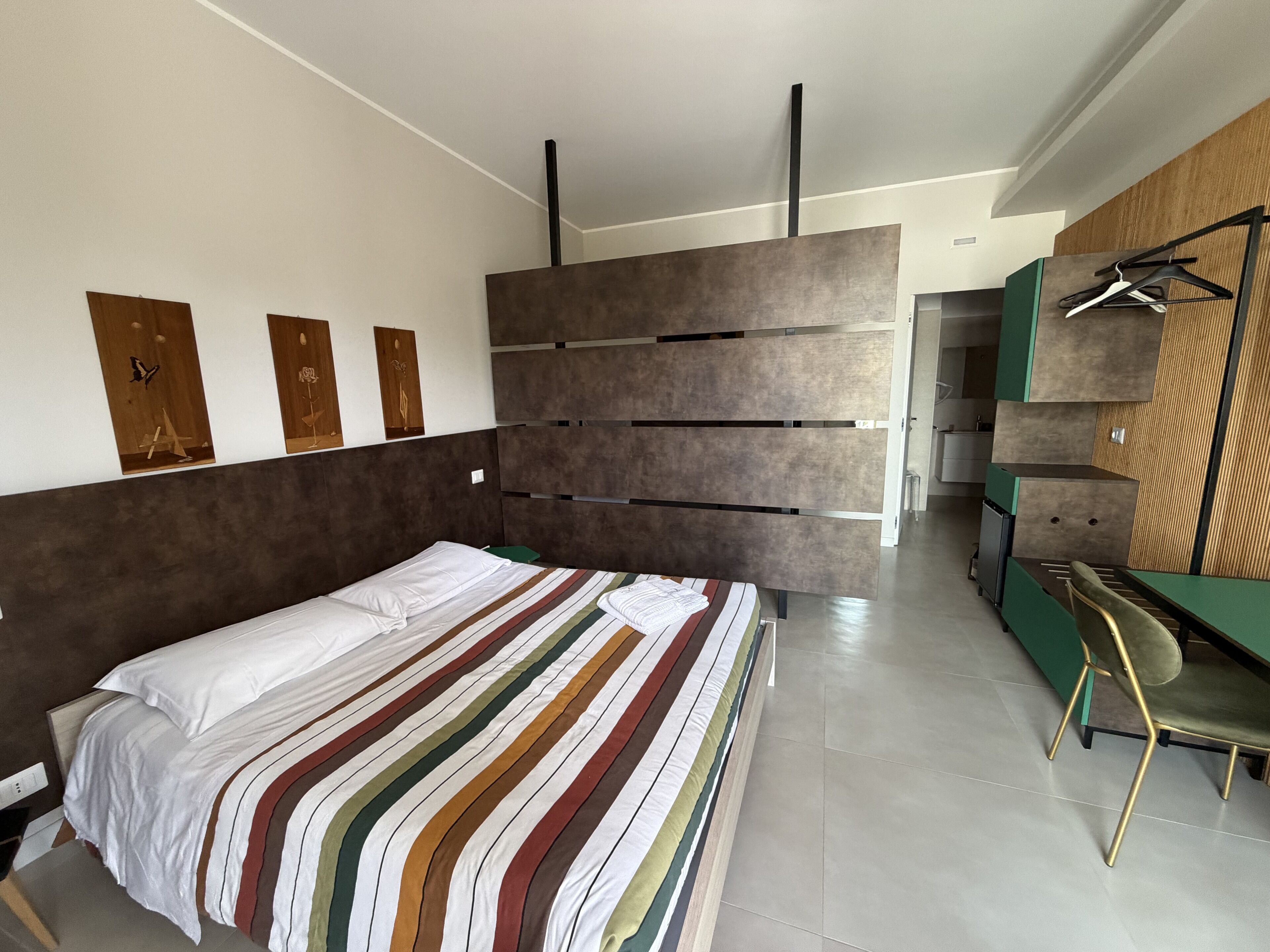 Deluxe Quadruple Room, Patio | In-room safe, desk, laptop workspace, blackout drapes