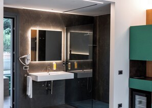 A modern bathroom with two sinks, a large mirror, and a hairdryer. - Tenuta San Marco (Noto)