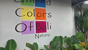 A wall with the text "United Colors of Bali Nature" in colorful letters. - UNITED COLORS OF BALI NATURE (Tibubeneng)