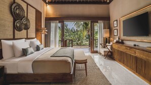 A spacious bedroom with a large bed, a wooden headboard, a television, and a view of the outdoors. - Maar Resort Ubud by Ini Vie Hospitality (Payangan)