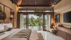 A spacious bedroom with a large bed, a bench, a desk, and a television. There is a sliding glass door leading to a balcony with a view of greenery. - Maar Resort Ubud by Ini Vie Hospitality (Payangan)