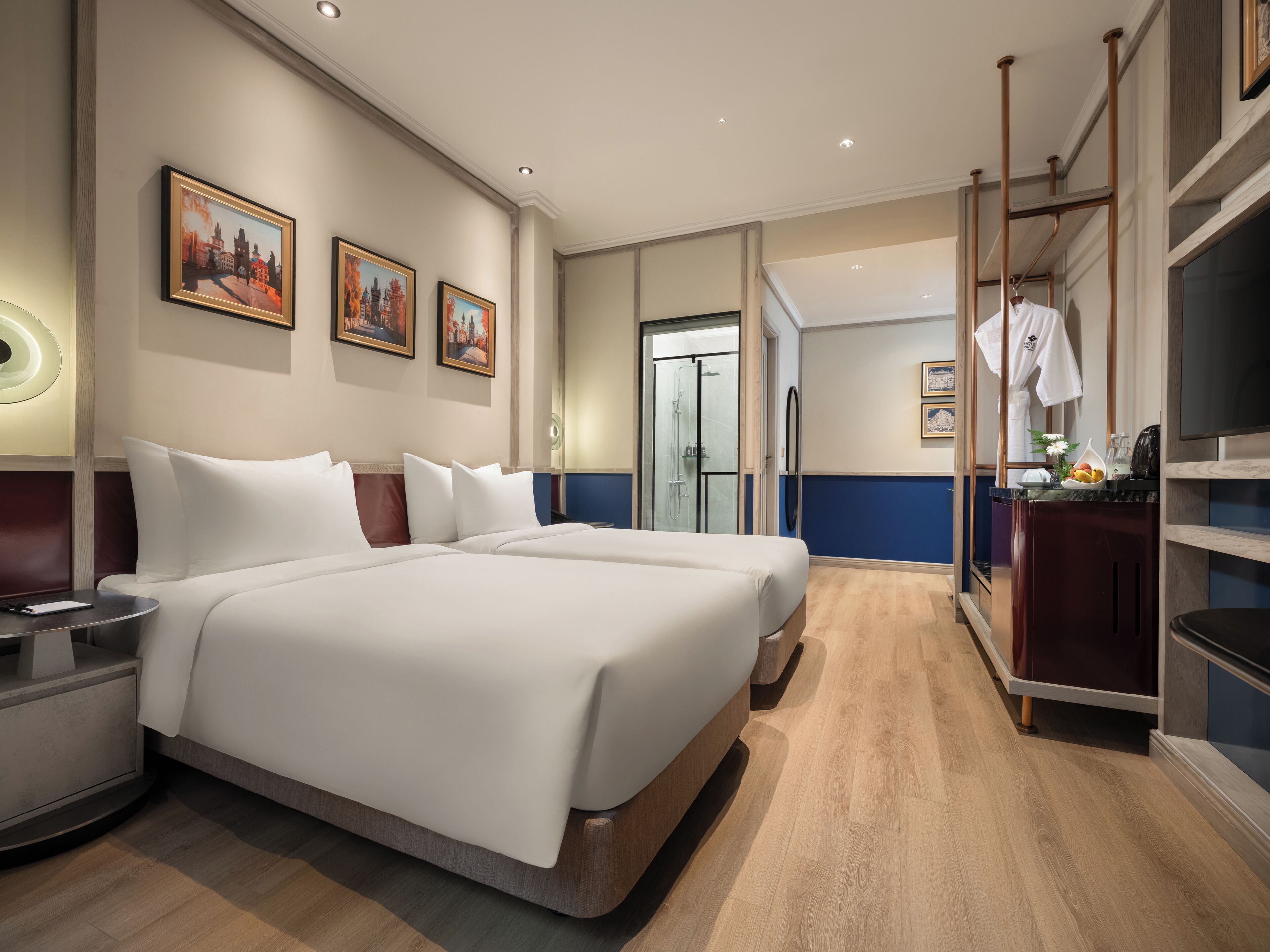 A hotel room with a large bed, a bedside table, a mirror, and a wardrobe.
