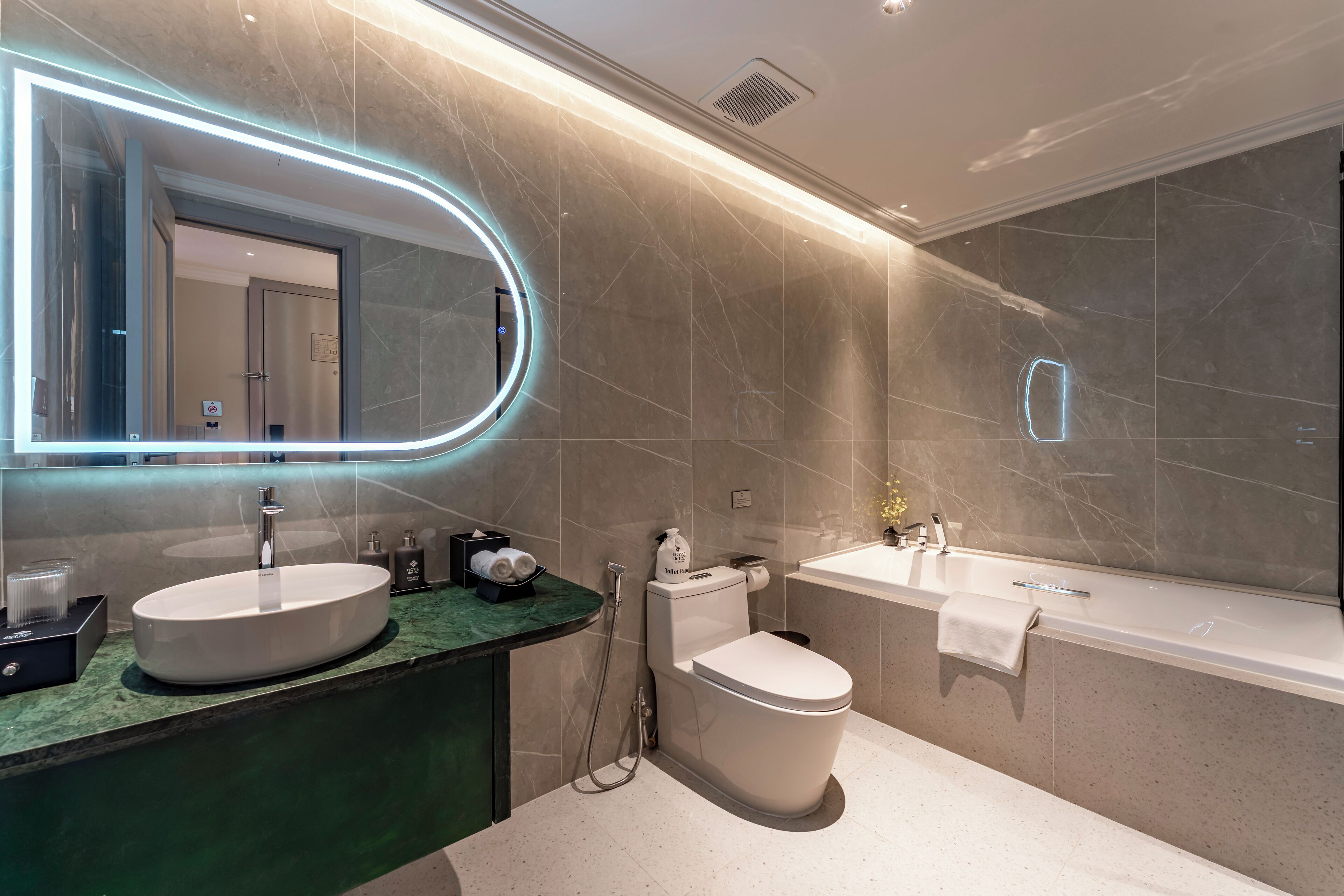 Ein modernes Badezimmer mit zwei Waschbecken, einer Toilette und einer Badewanne.