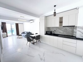 Apartment, Balcony, Partial Sea View | Private kitchen | Microwave, stovetop, electric kettle, highchair