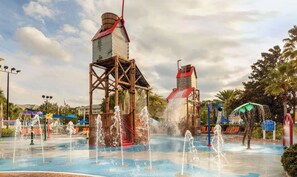 A water park with multiple water features including fountains and water slides.