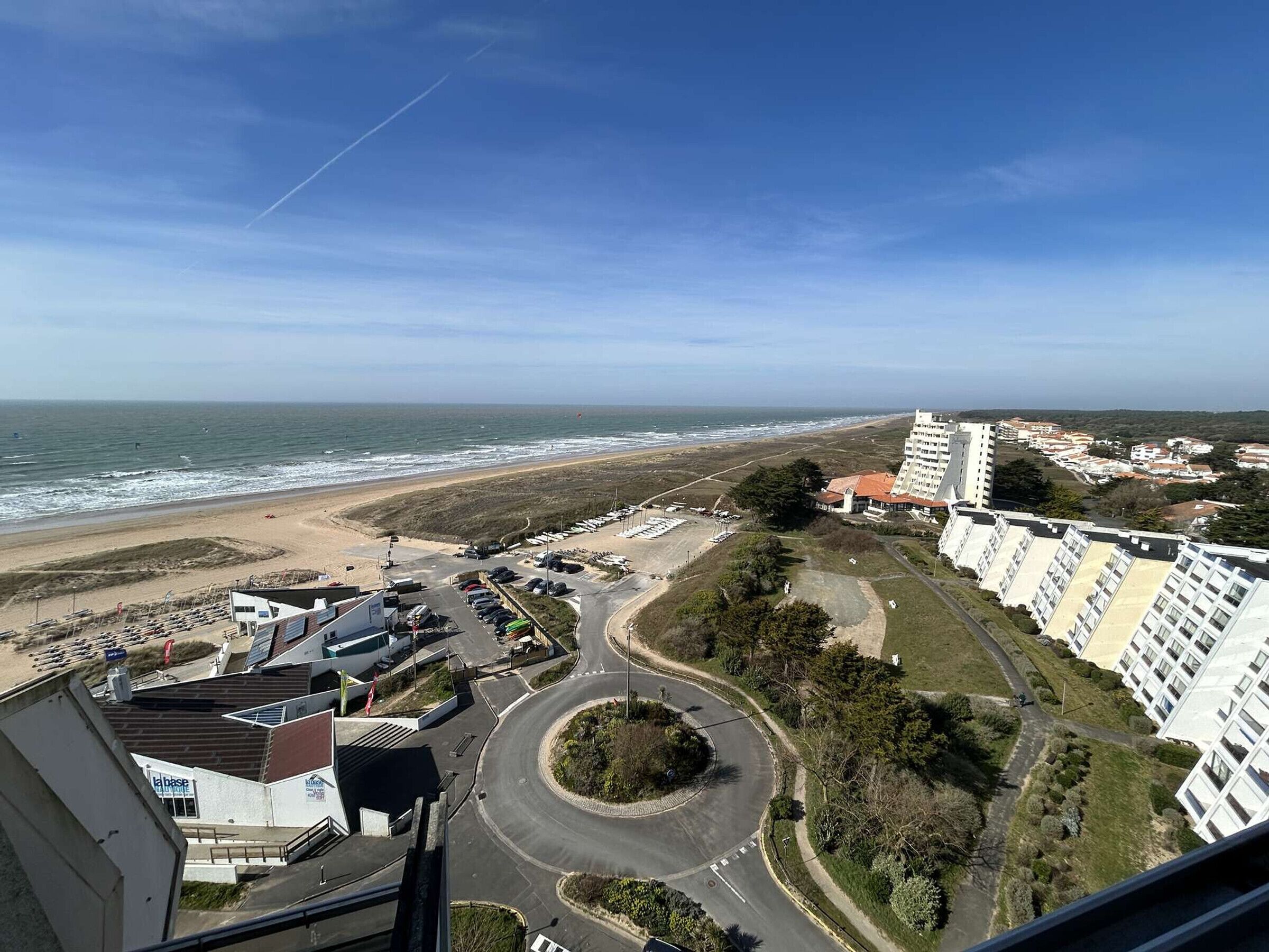 Vista costera con playa, una glorieta y edificios altos.