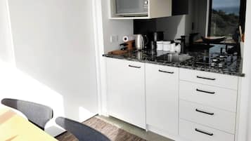 Fridge, microwave, stovetop, coffee/tea maker