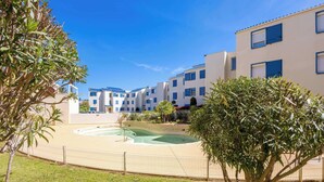 A residential building with a swimming pool, surrounded by greenery and a fence. - Valras’Loc – Rated apartment with pool & quiet terrace (Valras-Plage)
