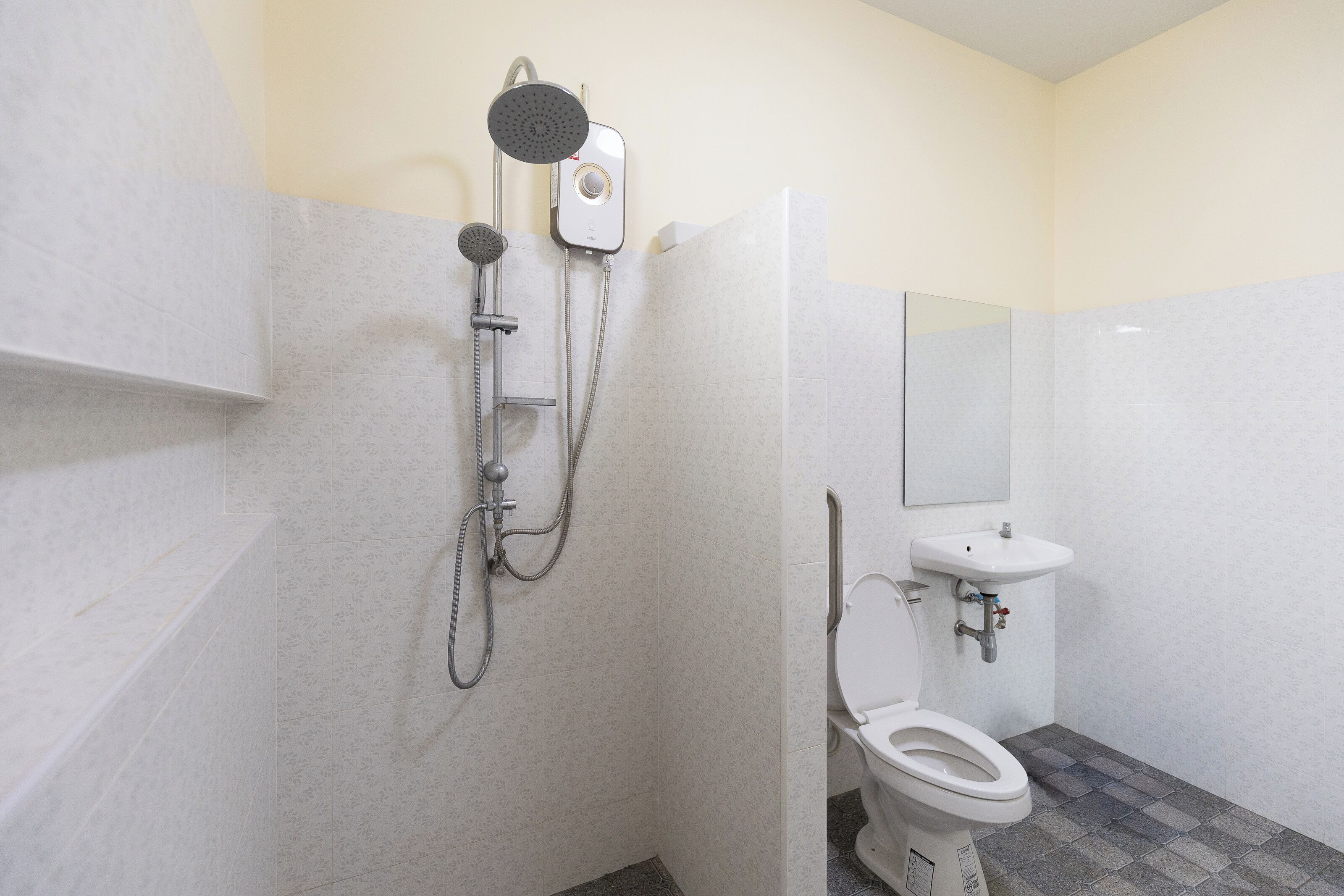 A bathroom with a shower, toilet, and sink.