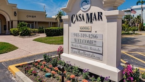A sign for Casa Mar with a contact number and a welcome message for weekly/monthly rentals. - 19 Premium Plus - Coastal Comfort (Sarasota)