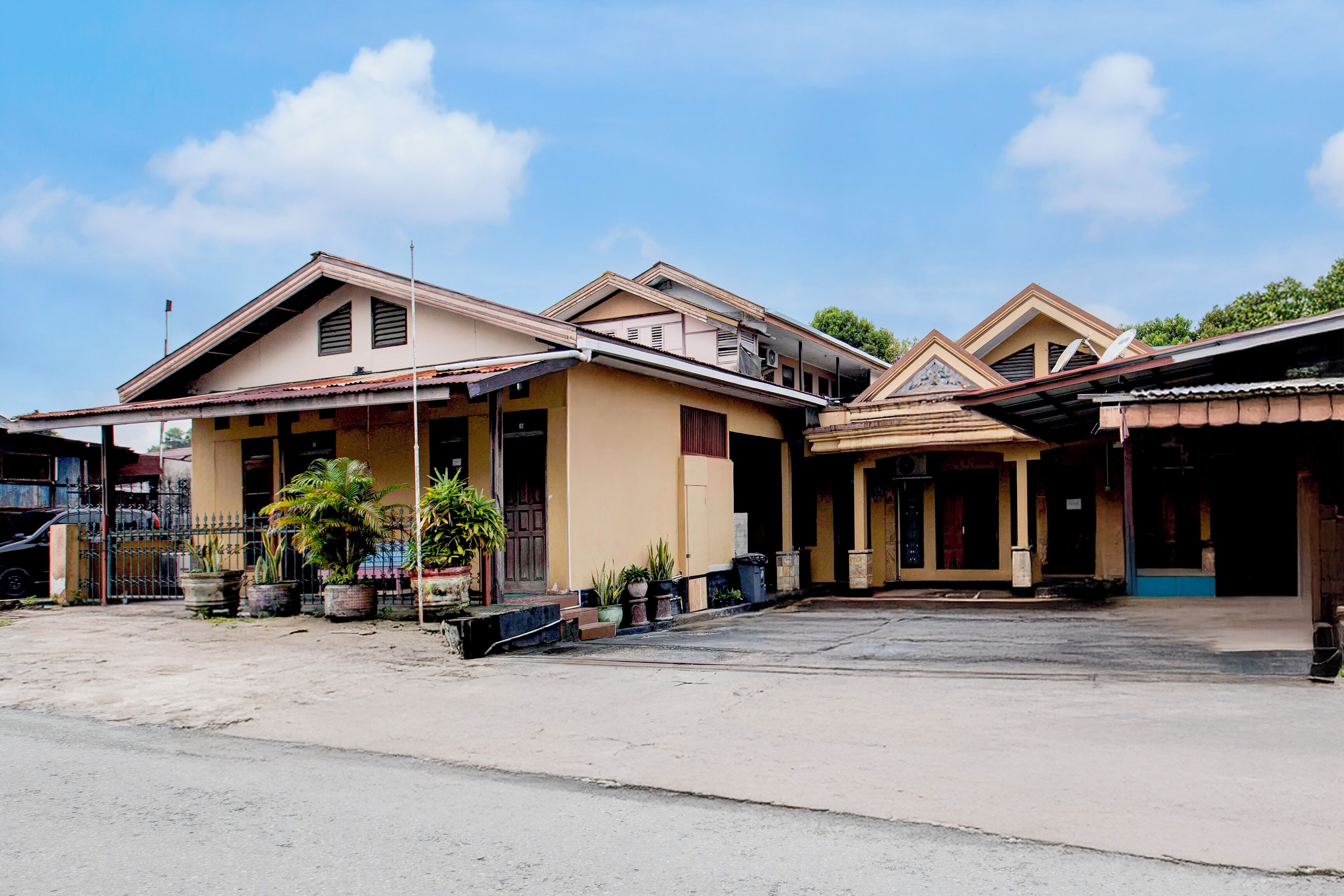 A row of two-story buildings with a flat roof and a central entrance.