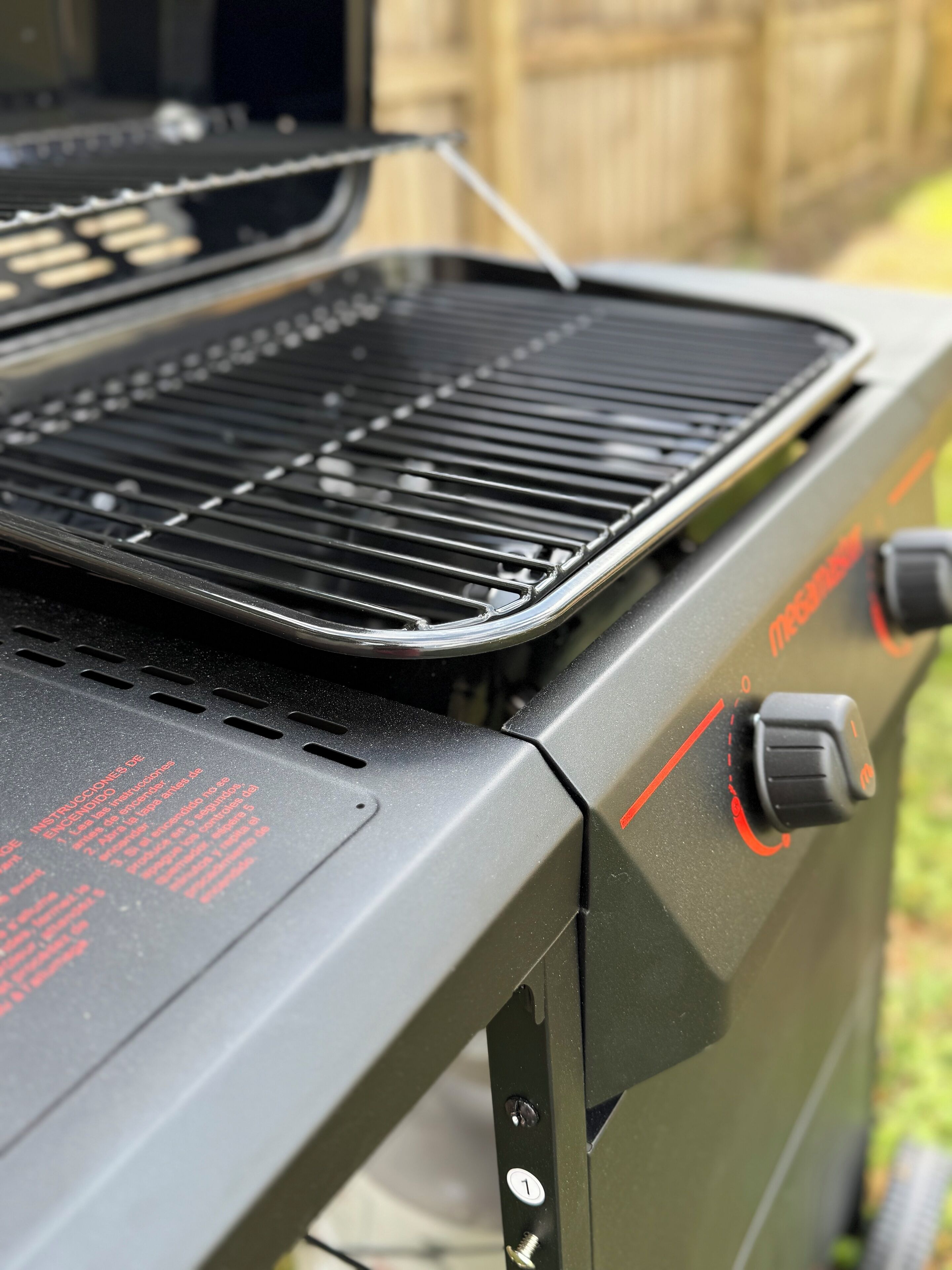 A grill with a control panel and a vent.