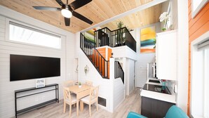 A modern interior with a dining area, a staircase, a kitchen, and a living room. - Lucky Break, River Views at Roadrunner Resort (Parker)