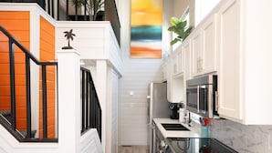 A modern kitchen with white cabinetry, a black countertop, and a stainless steel oven. - Lucky Break, River Views at Roadrunner Resort (Parker)