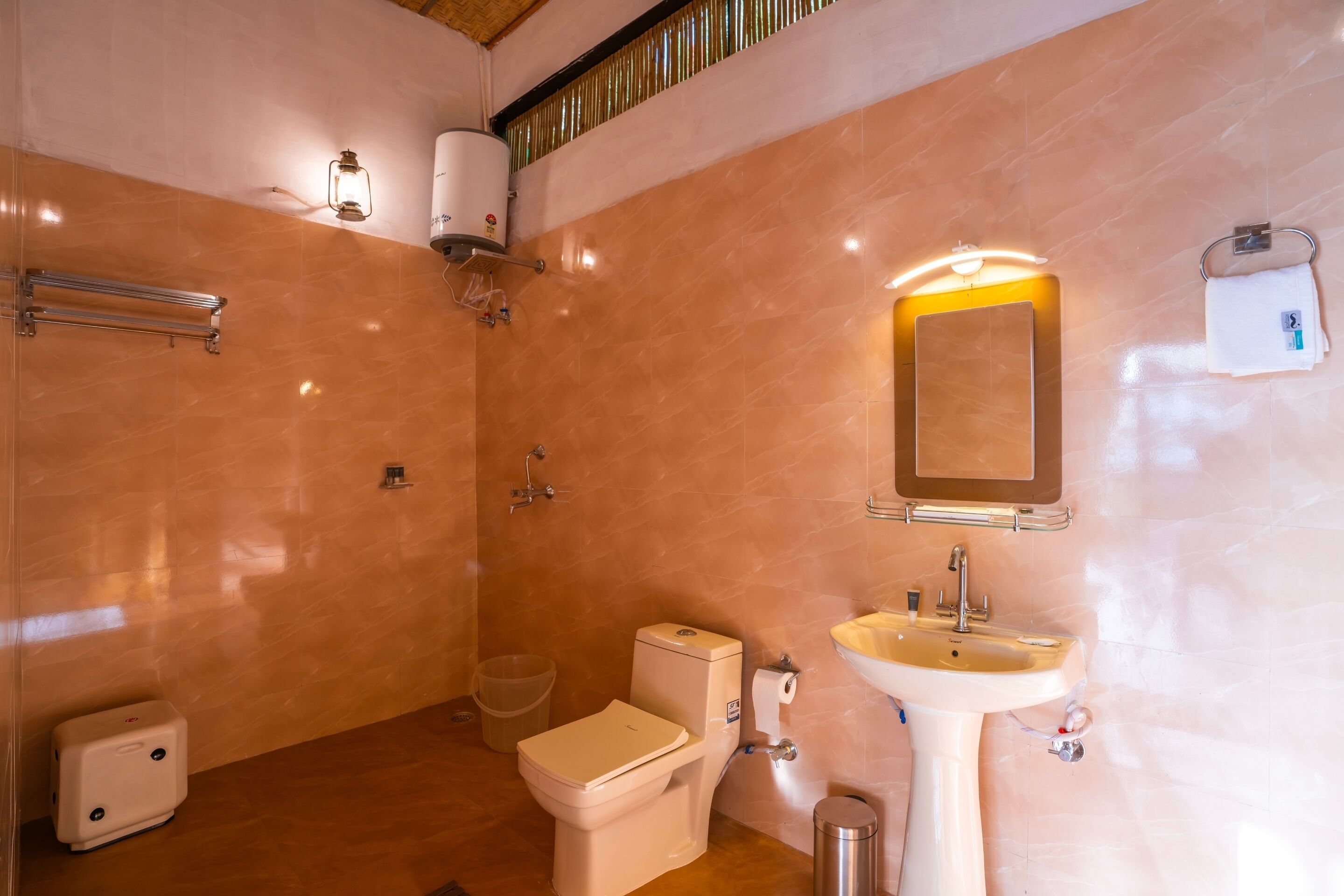 A bathroom with a toilet, sink, and shower.