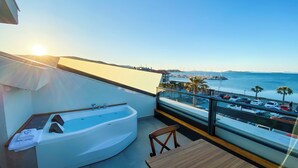 A balcony with a jacuzzi, a view of the sea, and parked cars. - THE PİER OF URLA (Urla)