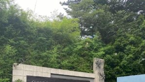 Señal de Swiss-Garden Residences con un camino despejado que lleva a la recepción.