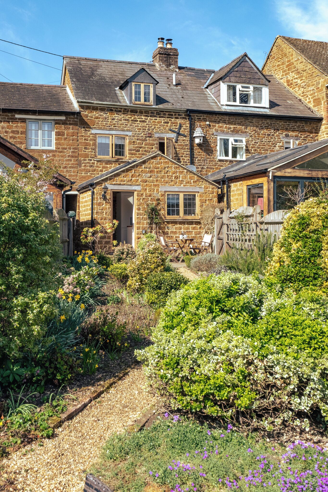 A stone house with a garden.