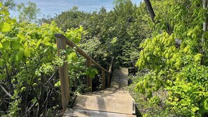 A wooden staircase leading to a viewpoint overlooking the sea. - Birch Beach Lake House-Hot tub/Sauna, Lake Access (Goderich)
