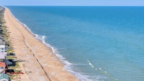 A beach with a row of houses along the shoreline. - Sea Haven - Oceanfront home w/beach access & deck (Ponte Vedra Beach)