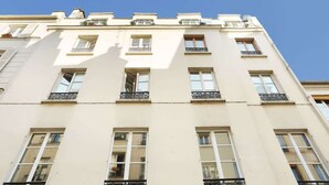 A multi-story building with a flat facade, multiple windows, and balconies.