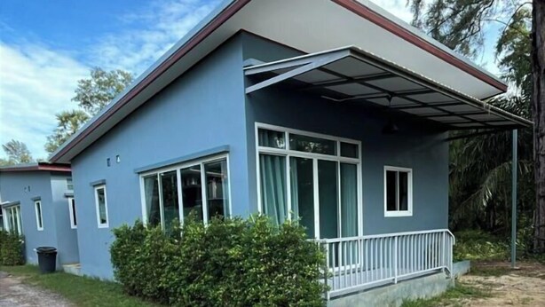A two-story building with a covered porch and a gravel driveway. - 2bdr BangTao House (Choeng Thale)