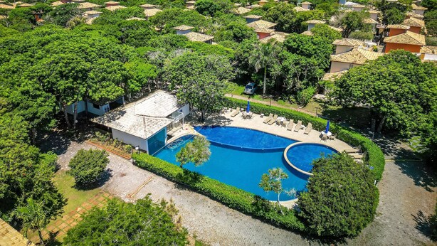 A resort with multiple swimming pools surrounded by lush greenery and Mediterranean-style villas.