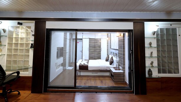 A modern interior with a sliding glass door leading to a bedroom.