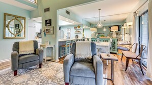 A spacious living room with two armchairs, a coffee table, and a dining area. - 7 Mi to The Wharf: Gem w/ Beach Access (Orange Beach)