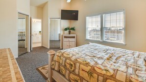 A bedroom with a bed, a ceiling fan, a TV, a window with blinds, a dresser, and a mirror. - Half-mi to Wildwood Boardwalk: Family-friendly Apt (Wildwood)