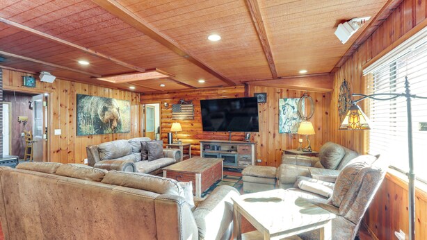 A cozy cabin interior with a wooden ceiling, a television, leather sofas, and a fireplace. - 16 Mi to Mogollon Rim: Home w/ Deck in Payson! (Payson)