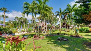 A tropical resort with palm trees, a pool, and a gazebo. - Fish On-site: Okeechobee Cabin w/ Pool Access (Okeechobee)