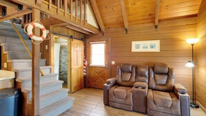 A wooden interior with a staircase, a reclining chair, and a lamp. - Lake Okeechobee Cabin w/ Boat Launch & Patio (Okeechobee)