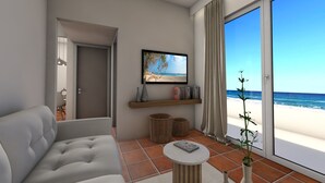 Een moderne woonkamer met een bank, een aan de muur bevestigde televisie, een boekenkast en uitzicht op het strand door een schuifdeur.