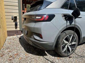 A vehicle parked in front of a building with a visible power outlet. - Hemlock Haven – Perfect for Groups of 16 (Pikeville)