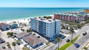 A multi-story hotel with a flat roof, located near a beach with a clear view of the ocean. - San Remo 304 2BR Beachfront Condo (Redington Shores)