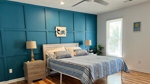 A bedroom with a bed, wooden nightstands, a ceiling fan, and a window. - 604 Wedgewood 3 Bedroom Home (North Myrtle Beach)